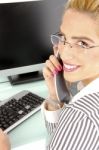 Smiling Woman Busy On Phone Stock Photo