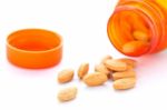 Closeup Of Orange Pills And Pill Bottle Stock Photo