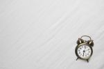 Clock On Bed Stock Photo