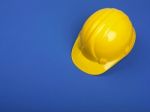 Yellow Hard Hat On Blue Stock Photo