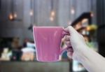 Woman Hand Holding Coffee Cup With Blurred Background Stock Photo