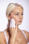 Young Woman Clean Face With Wet Wipes Stock Photo