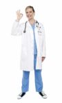 Female Doctor Gesturing Ok Sign Stock Photo