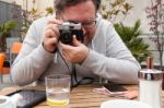 Young Man Traveler Shooting A Vintage Camera Stock Photo