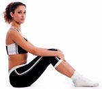 Young Woman In Fitness Outfit Sitting On The Floor Stock Photo