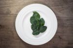 Kaffir Lime Leaves In Ceramic Dish On Wood Background Stock Photo