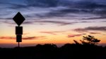 Road Sign Silhouette And Colorful Sunset Stock Photo