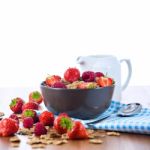 Bran Flakes With Fresh Raspberries And Strawberries And Pitcher Stock Photo