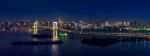 Panorama Of Tokyo Cityscape And Rainbow Bridge At Night Stock Photo