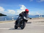 Young Man Riding Big Bike Motorcycle Against Sharp Curve Of Asph Stock Photo