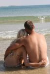 Couple Relaxing At Beach Stock Photo