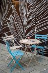 Table And Chairs In A Street In Munich Stock Photo