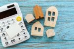 Calculator And Wood House With Blank Card Stock Photo