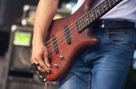 Hand Of Bass Guitarist In Concert Stock Photo