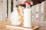 Pouring Espresso To Iced Glass Of Coffee Stock Photo