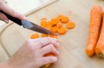 Pretty Young Woman Cutting Vegetables In The Kitchen Stock Photo