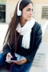 Beautiful Girl Listening To Music In City Stock Photo