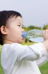 Little Asian Girl  Drinking Water From Plastic Bottle Stock Photo