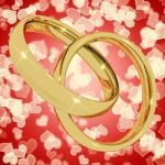 Gold Rings On Heart Background Stock Photo