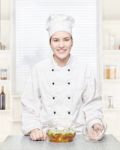 Chef With A Soup In A Glass Pot Stock Photo