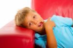 Boy On Red Sofa Stock Photo