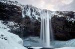 View Of Seljalandfoss Waterfall In Winter Stock Photo