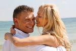 Smiling Couple At Beach Stock Photo