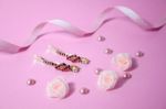 Golden Hairpins With Pink Gemstone On Pink Background Stock Photo