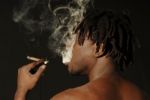 Smoking African Man Stock Photo