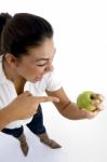 Young Model Indicating Apple Stock Photo