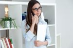 Confident Young Woman Working In Her Office With Mobile Phone Stock Photo