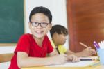 Kindergarten Students Painting In Classroom Stock Photo