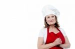 Portrait Of A Smiling Female Chef, Hands Clasped Stock Photo