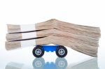 Stacks Of Banknotes On Toy Car Wheels Stock Photo