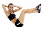 Fit Woman In Sporty Attire Doing Crunches Stock Photo