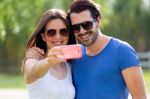 Happy Young Couple Taking Selfies With Her Smartphone In The Par Stock Photo