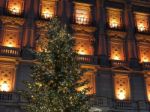 Christmas Tree In Front Of A Bright Building Stock Photo