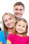 Husband Posing With His Adorable Wife And Daughter Stock Photo