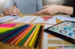 Two Young Women Working As Fashion Designers And Drawing Sketche Stock Photo