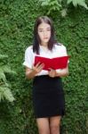 Thai Adult Student University Beautiful Girl Reading Red Book Stock Photo