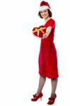 Woman In Red Giving Away Xmas Gift Stock Photo