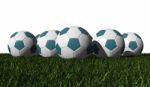 Cyan Soccer Balls On A Green Grass Stock Photo