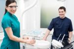 Orthodontist With Female Assistant In Clinic Stock Photo