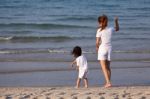 Asian Mom And Son On Beach Stock Photo