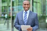 Relaxed Businessman Using His Digital Tablet Stock Photo