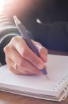 Woman Hand With Pen Writing On Notebook Stock Photo