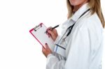 Cropped Image Of Doctor Writing On Clipboard Stock Photo