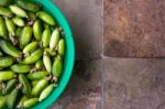 Ivy Gourd Soaking In Water On Vintage Tiles Stock Photo