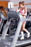 Woman On Running Machine In Gym Stock Photo