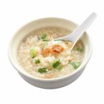 Congee Round Bowl And Spoon On White Background Stock Photo